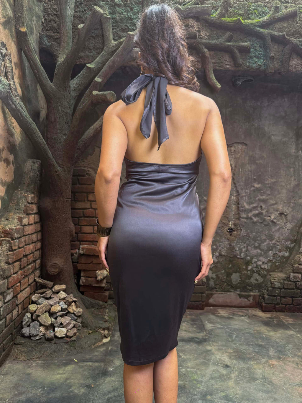 Noctural Black satin dress. a woman in a dress posing for a picture